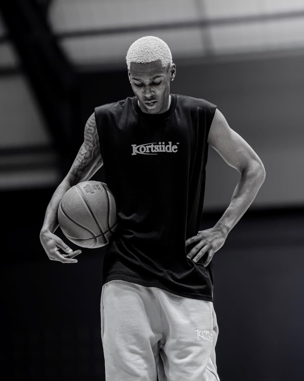 Jordan Lewis holding a basketball on the court